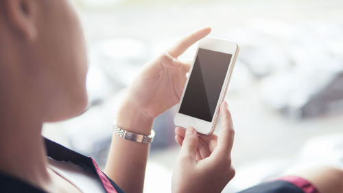 Close-up of hand using mobile phone