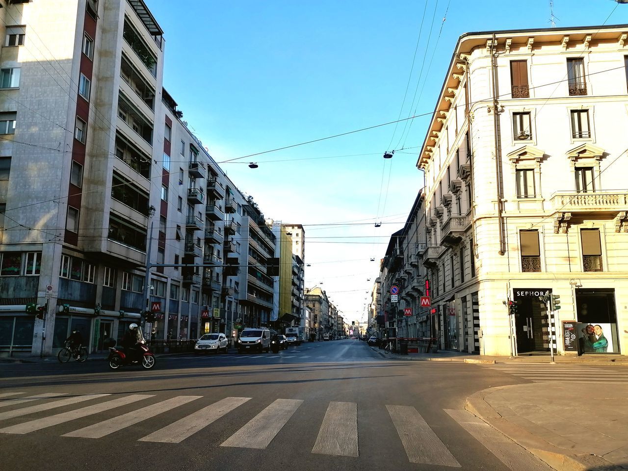 CITY STREET BY BUILDINGS AGAINST SKY