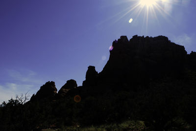 Silhouette rock against sky