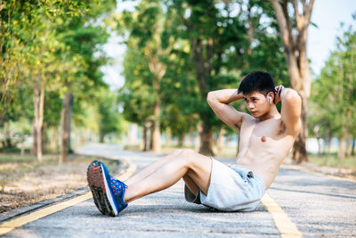 Side view of young man relaxing outdoors