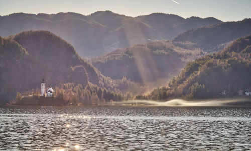 Scenic view of lake and mountains against sky