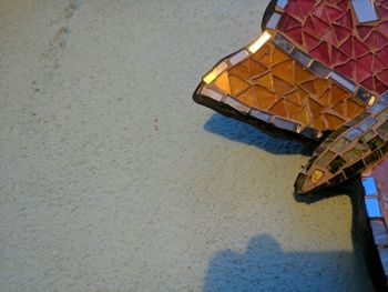 High angle view of wet yellow umbrella on beach