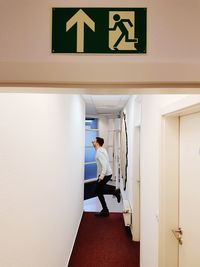 Full length of man standing at entrance of building