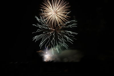 Low angle view of firework display at night