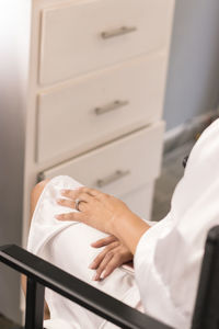 Midsection of woman on chair