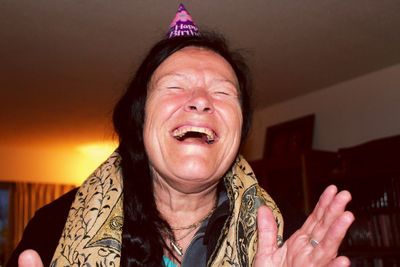 Close-up of cheerful senior woman at home