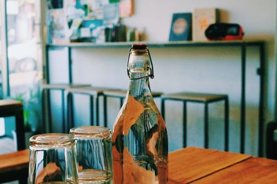 Close-up of glass water bottle on table