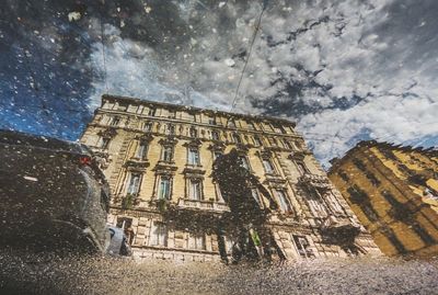 Low angle view of buildings in city against sky