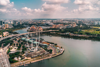 High angle view of river amidst buildings in city against sky