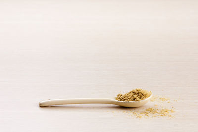 Close-up of bread on table against white background