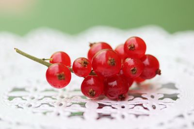 Close-up of red berries on lace