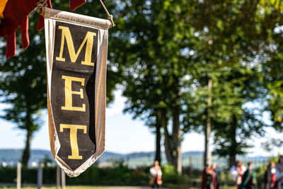 Close-up of road sign against trees