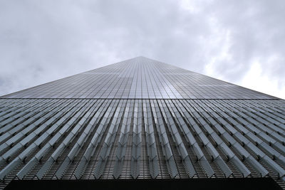 Low angle view of modern building against cloudy sky