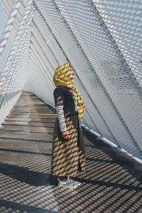 Rear view of woman walking on staircase