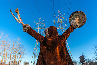 Low angle view of statue against blue sky