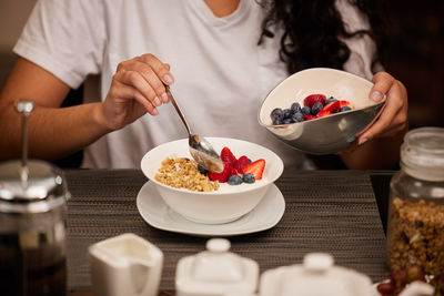 Midsection of woman preparing food on table