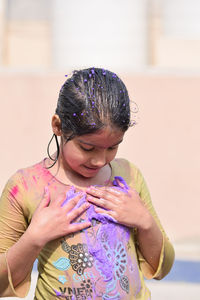 Girl playing with powder paint during holi