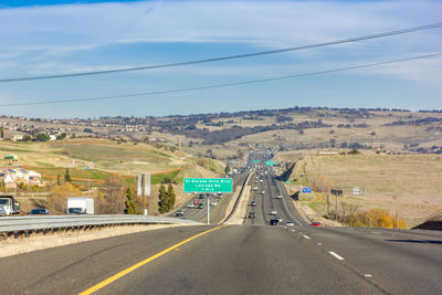 Road by bridge against sky