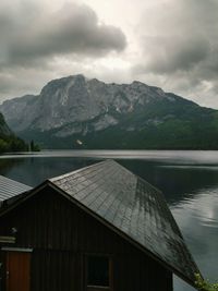 Scenic view of lake by mountains against sky