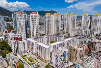 High angle view of modern buildings in city against sky