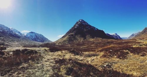 Scenic view of mountains against clear blue sky