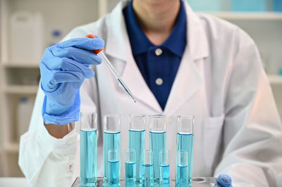 Midsection of scientist working in laboratory