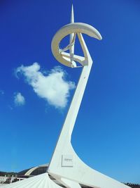 Low angle view of montjuic communications tower against blue sky