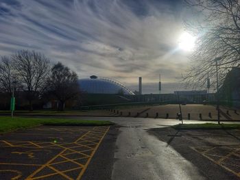 Empty road in city against sky