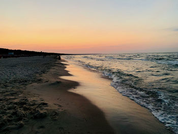 Scenic view of beach against sky during sunset