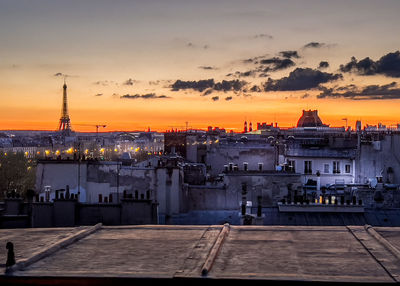 Buildings in city against sky during sunset