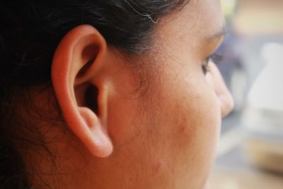 Cropped image of woman ear