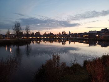 Scenic view of river against sky at sunset