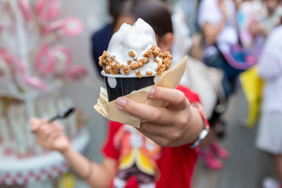 Midsection of a girl holding ice cream