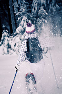 Person with umbrella on snow covered land