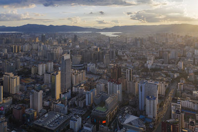 High angle view of modern buildings in city against sky