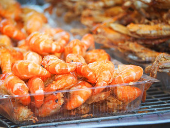 Grilled shrimps in the plastic box.