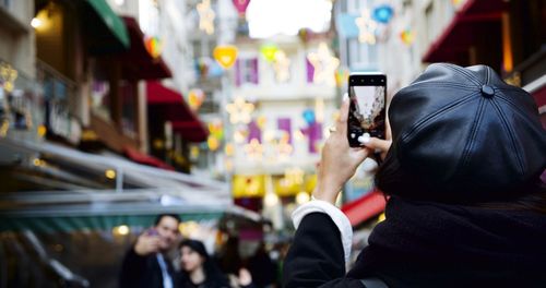 Rear view of man photographing