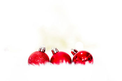 Close-up of christmas decorations over white background