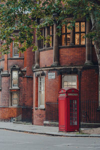 Red phone box on a street in clerkenwell, london, uk.