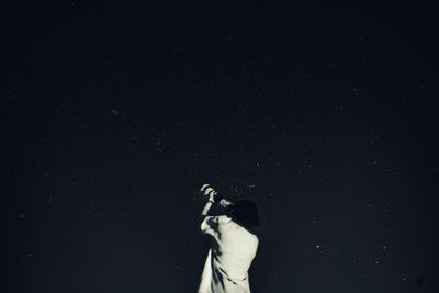 Silhouette man standing against black background