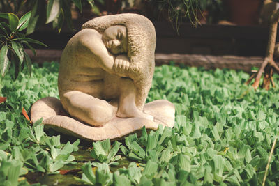 Statue against plants