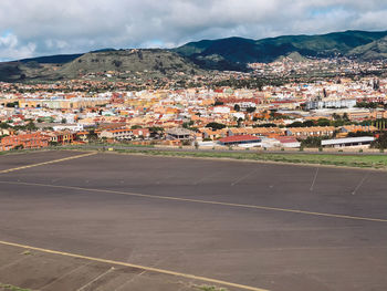 Town by buildings in city against sky