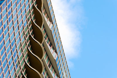 Low angle view of modern buildings against blue sky