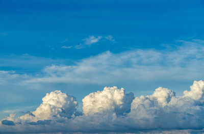 Vast white cumulus clouds with blue sky background