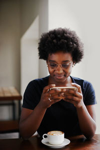 Portrait of woman holding coffee cup