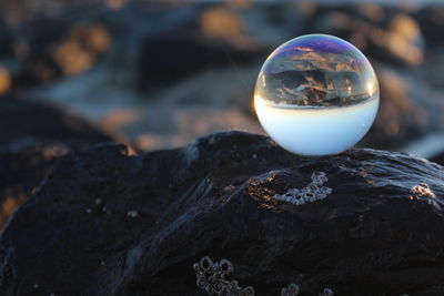 Close-up of crystal ball on rock