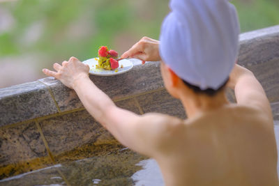 Cropped hand of woman holding plant