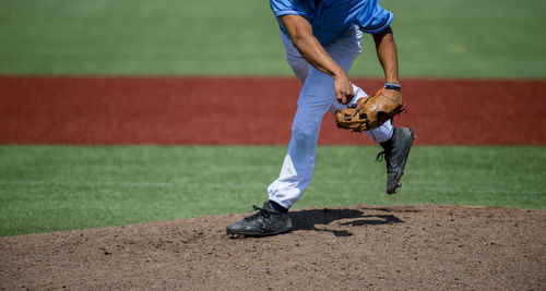 Low section of baseball player playing on field
