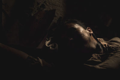 High angle view of woman lying on ground at night