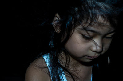 Close-up portrait of a girl in the dark